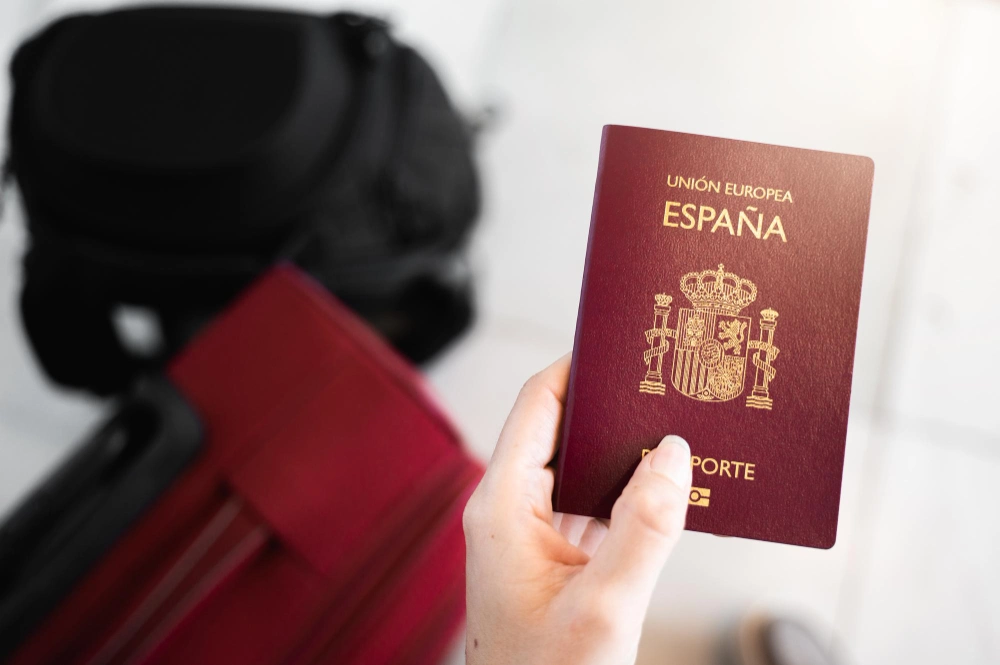 Closeup female hand holds Golden Spanish passport